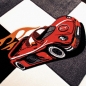 Preview: Kinderteppich Rennauto mit Creme Grau Rot Orange Schwarz
