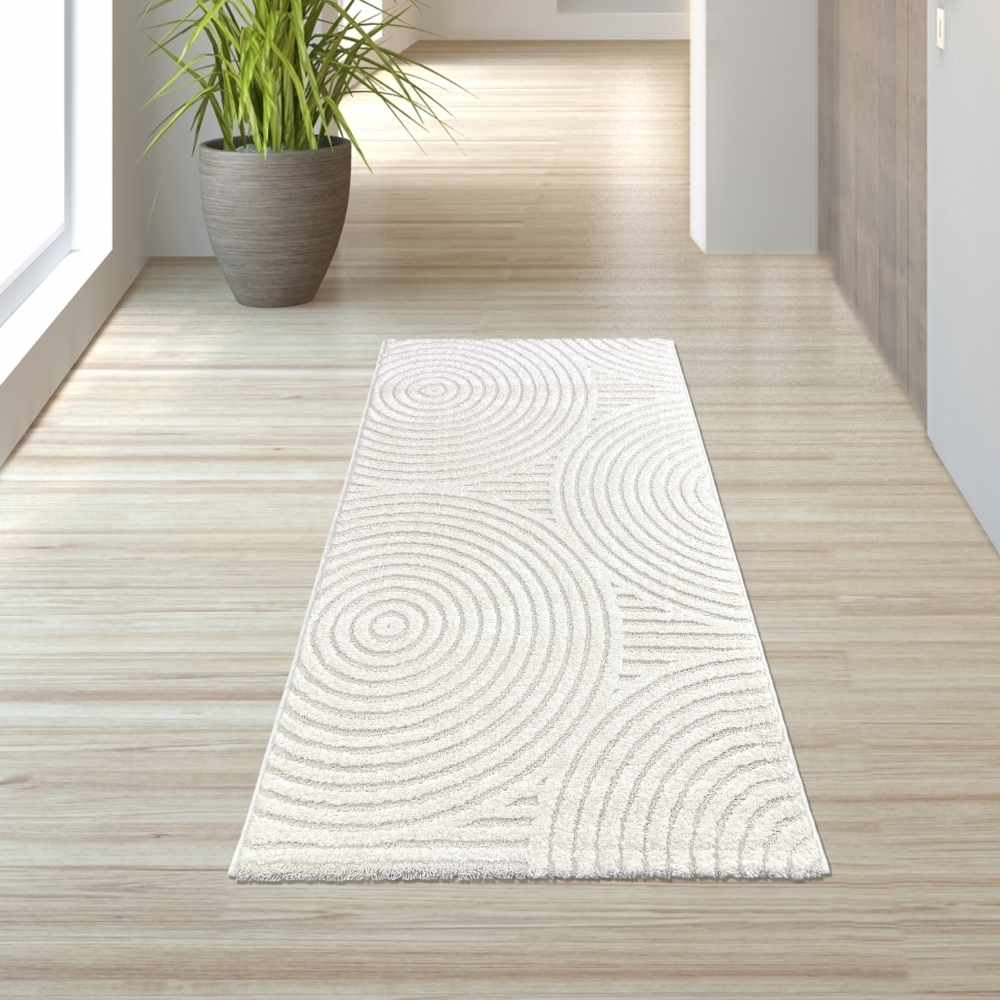 Eleganter Wohnzimmerteppich mit geometrischem Kreismuster in Creme